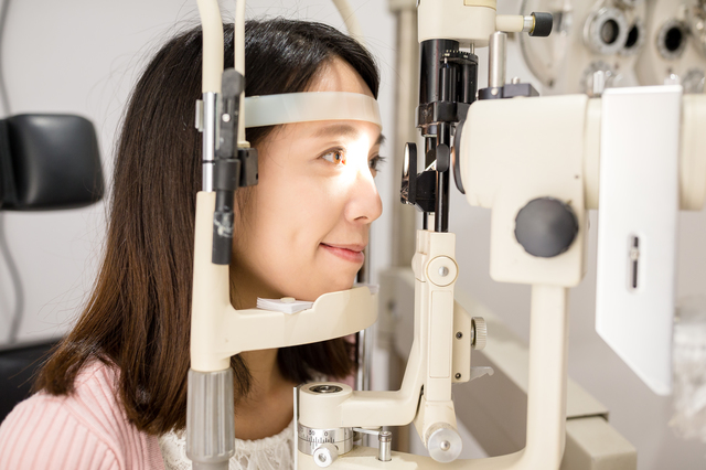 眼科で視力の検査を受けている女性